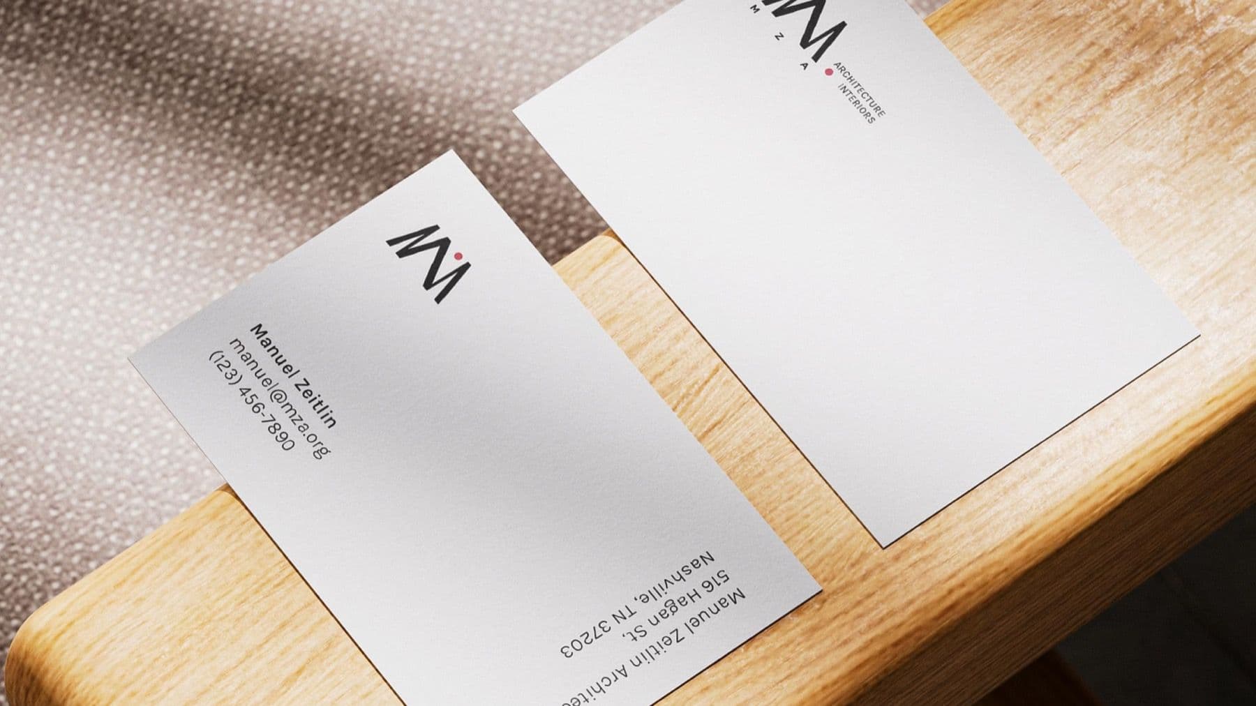 MZA business cards on a wooden table
