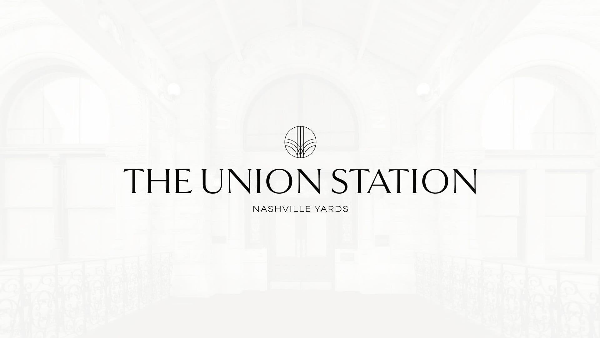 The Union Station Nashville Yards official logo centered over a bright, high-key architectural interior of the historic hotel lobby.