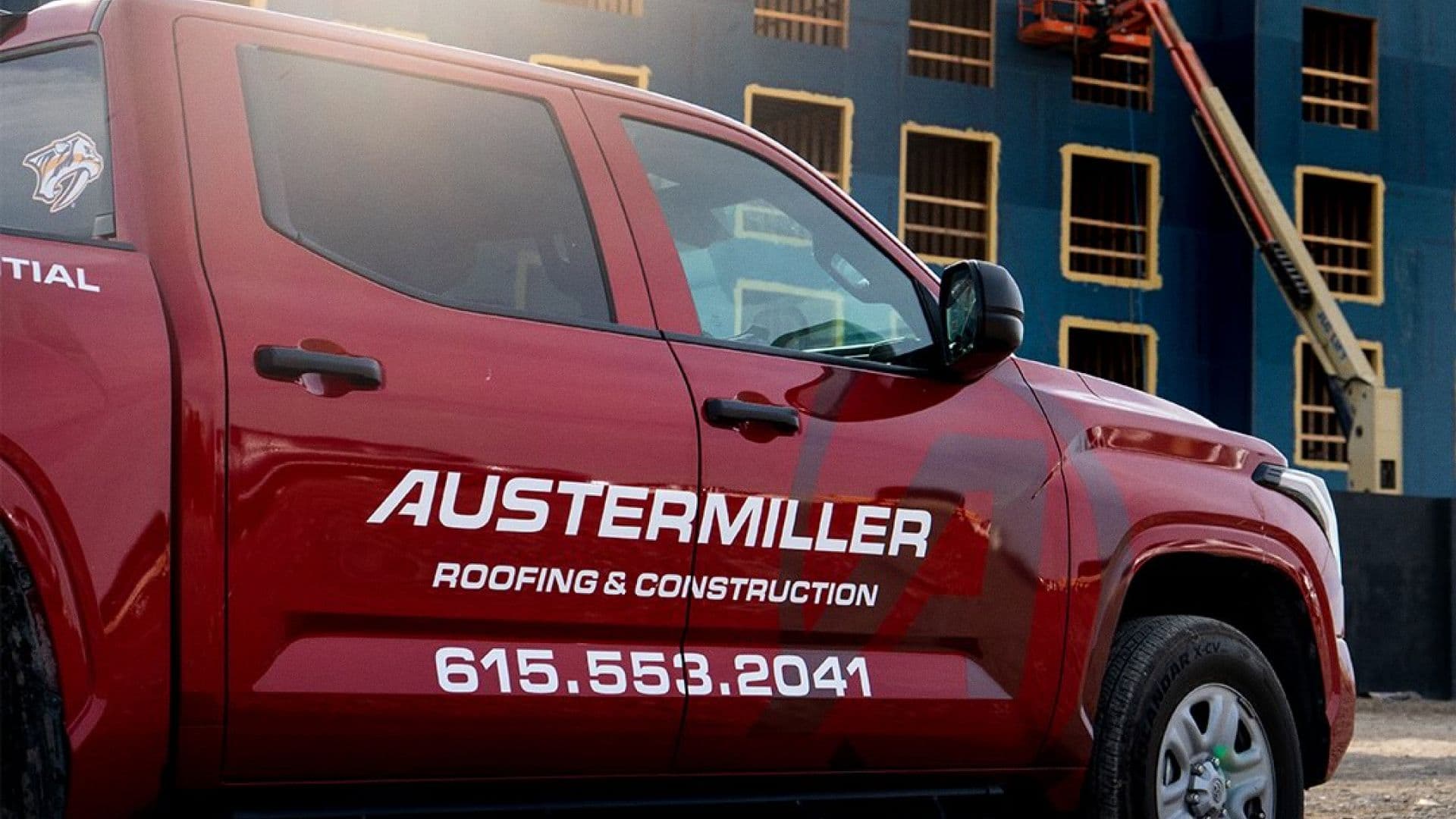 Red Austermiller work truck with the new logo and phone number