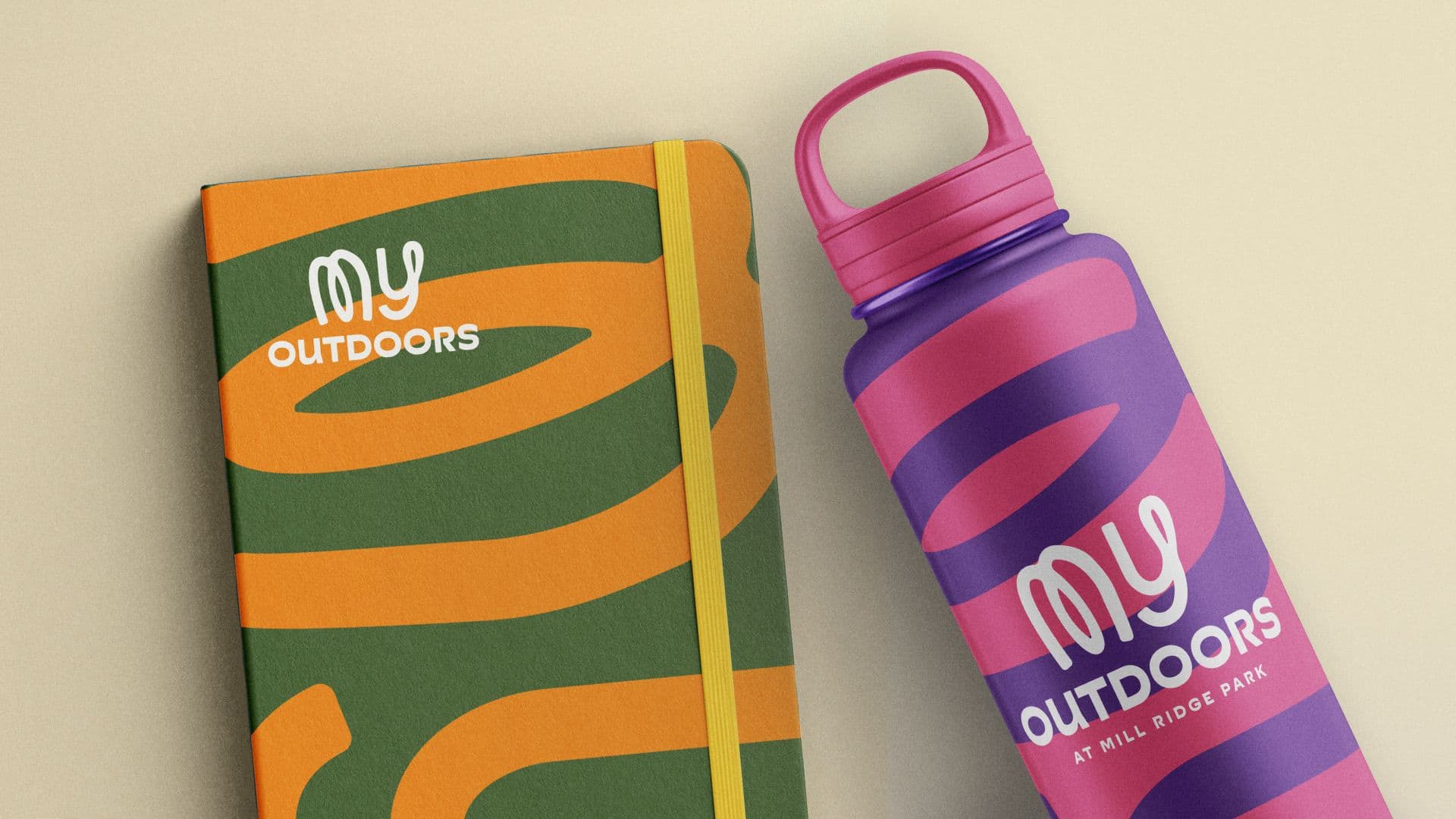 Branded notebook and purple water bottle featuring the "My Outdoors" Mill Ridge Park campaign logo.