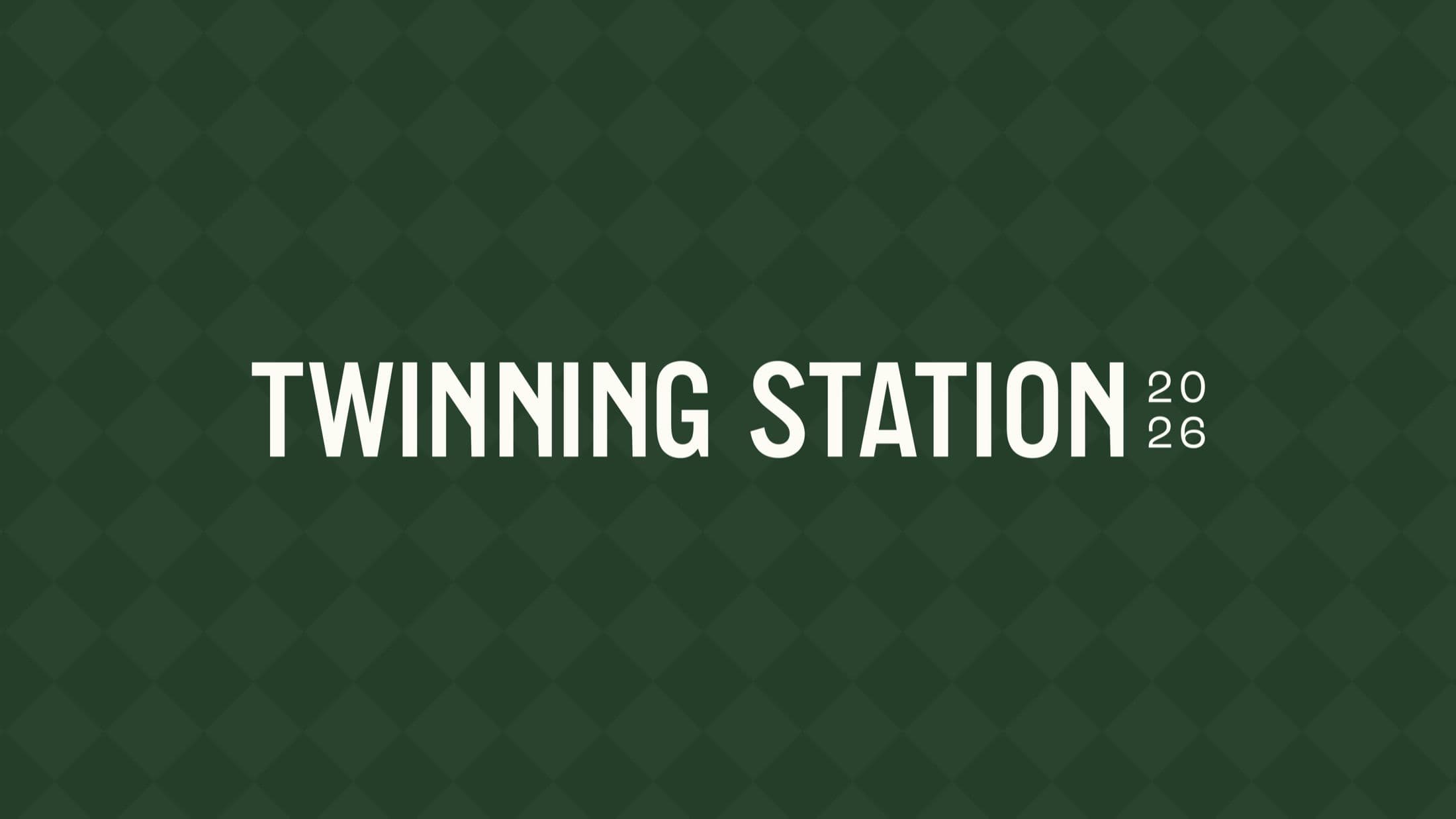 Twinning Station 2026 logo: A circular, dark-green emblem featuring two interlocking 'S' shapes, stylized to resemble a möbius strip or infinity loop, surrounding the number '26'