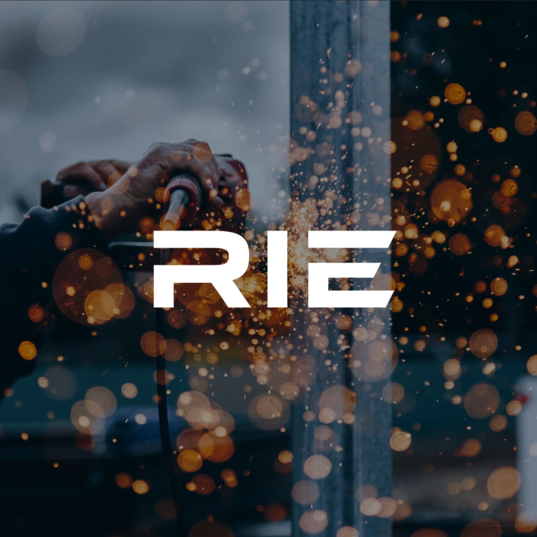 RIE Coatings logo over an industrial photo with sparks