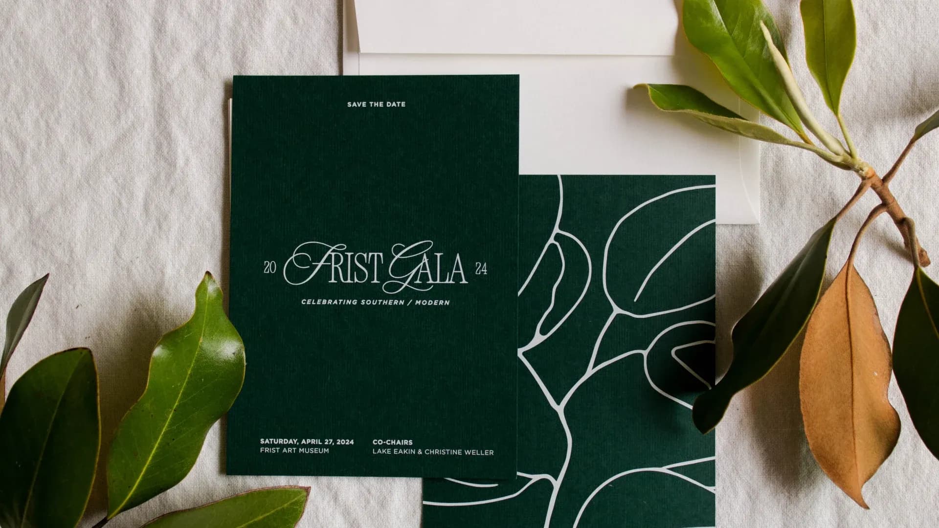 Save the date card front and back with a vignette of magnolia leaves