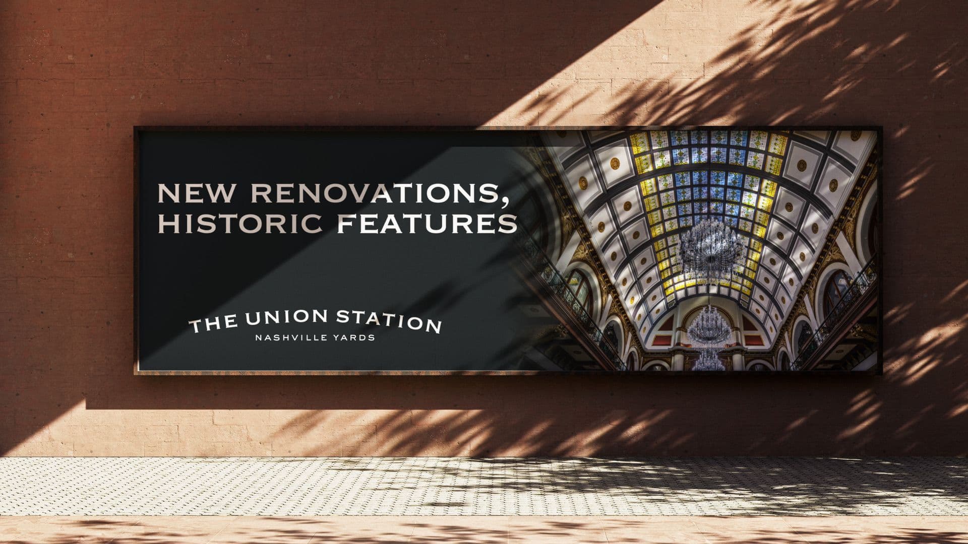 Outdoor billboard for The Union Station Nashville Yards featuring a grand vaulted stained-glass ceiling and chandeliers with the text "New Renovations, Historic Features."
