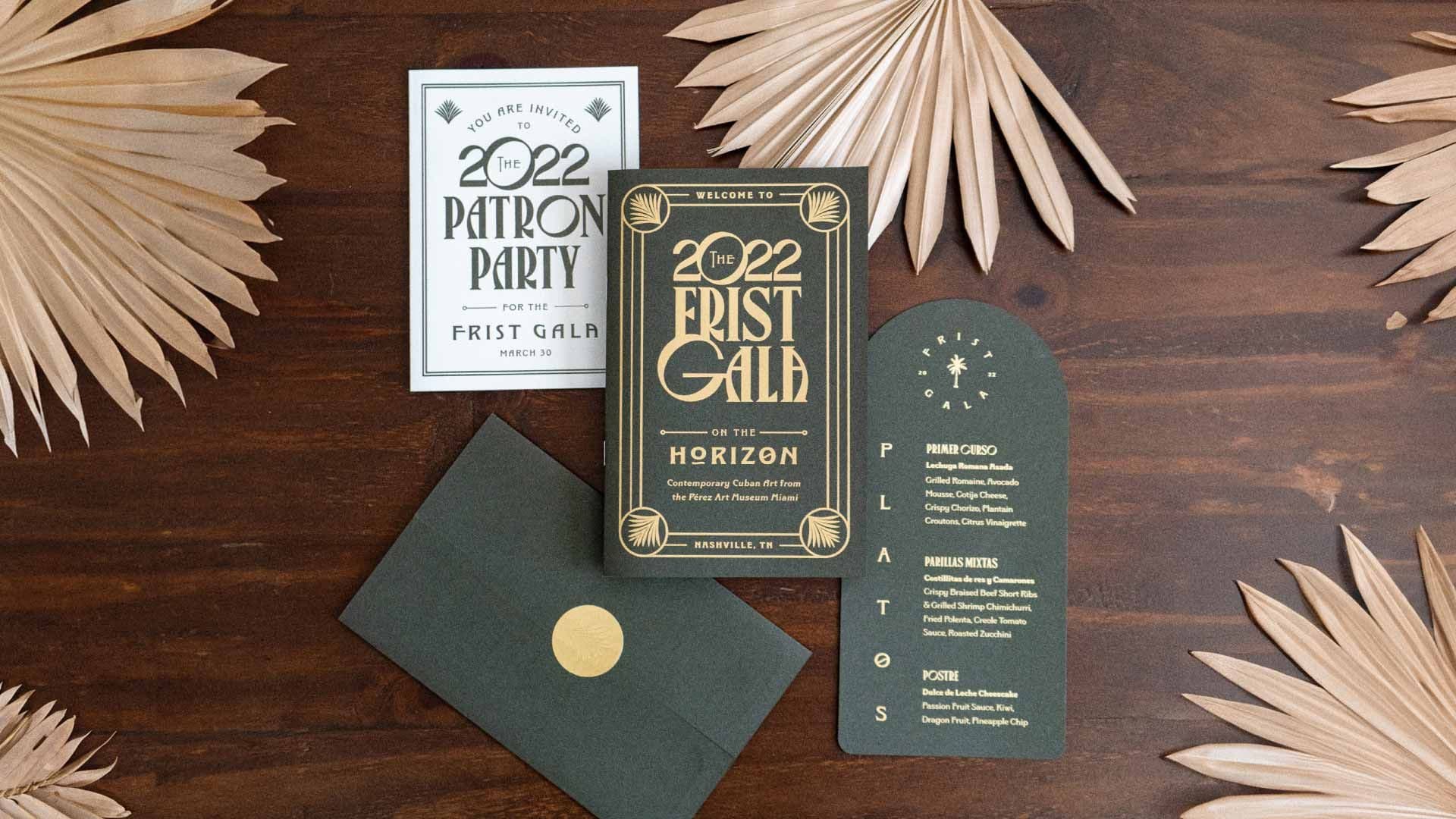Photo of the 2022 First Gala invitation suite on a dark wood background