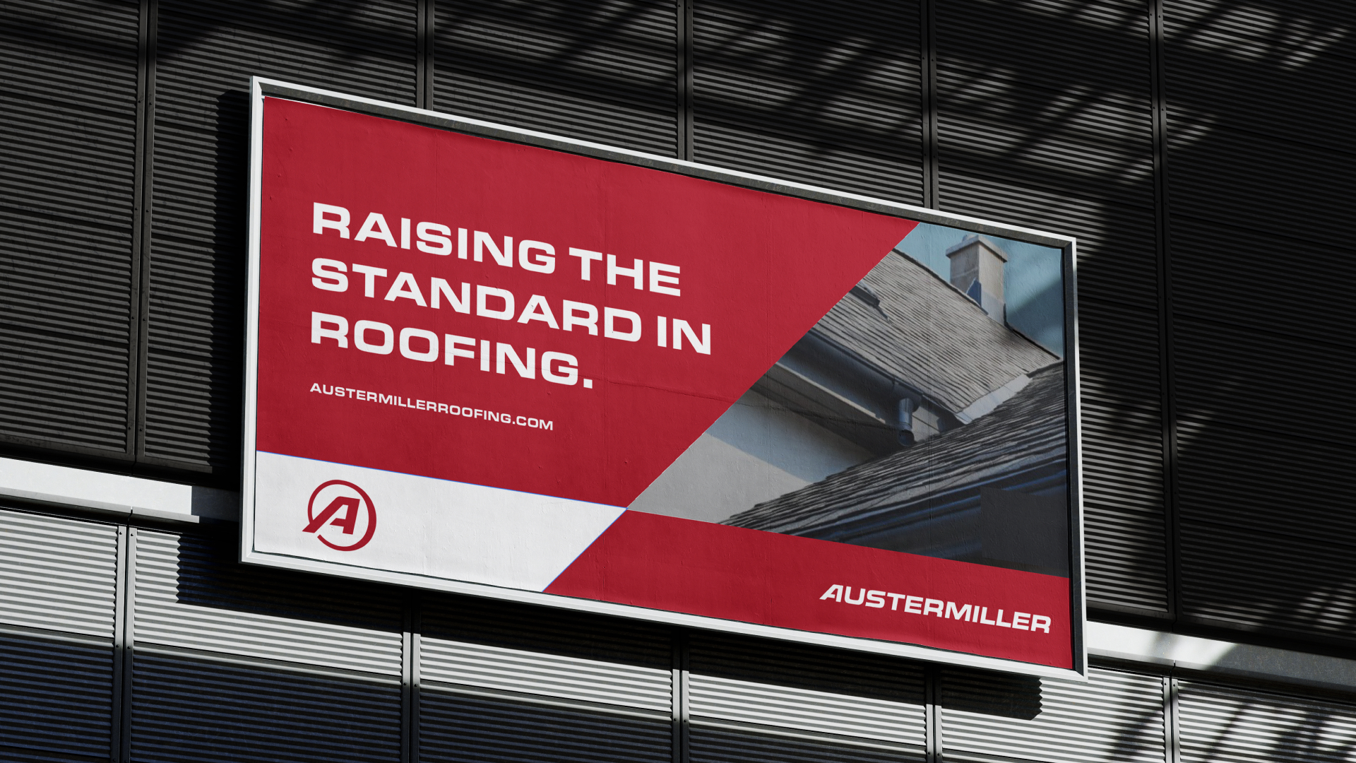 A billboard mockup with copy over Austermiller's branded red that reads "Raising the Standard in Roofing. Austermillerroofing.com" With a photo of a roof partially showing on the right. 